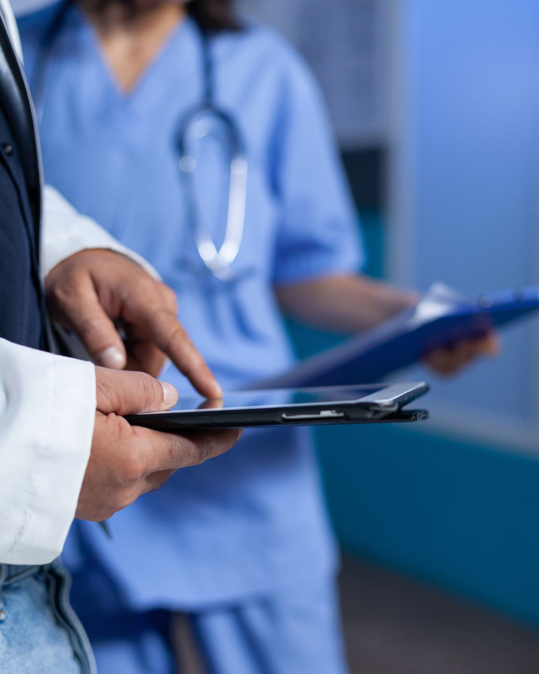 doctor-with-touch-screen-talking-assistant-about-healthcare-system-overtime
